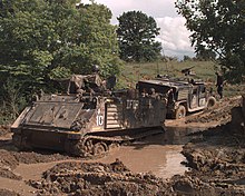 A U.S. Army M-113 Armor Personnel Carrier prepares to pull an armored Humvee out of the mud in Bosnia and Herzegovina. Defense.gov News Photo 960510-A-4901L-003.jpg