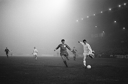 Cruyff playing for Ajax taking on Liverpool defender Tommy Smith in a European Cup game in December 1966