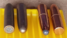 This image illustrates the jacket placement difference between full metal jacket bullets on the left and soft point bullets on the right. Both bullet types are 220-grain (14 g) .30-caliber. The silver-colored cupronickel jacketed bullets on the left have an enclosed rounded point with a jacket opening on the flat base, while the copper-colored gilding metal jacketed bullets on the right have an enclosed flat base with a jacket opening on the rounded point. If these bullets were loaded and fired in the opposite of their intended direction, the full metal jacket bullet might expand like a soft point, and the soft point bullet might perform like a full metal jacket. FMJorSPbullet.png