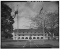 General view of east side with flags and monument, facing west. - Marine Barracks, Panama Canal, Barracks Building, 100' North of Thatcher Highway, Balboa, Former Panama Canal HABS CZ,1-BALB.V,3A-2.tif