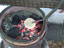 Kemplang being grilled on charcoal Grilling kerupuk kemplang.JPG