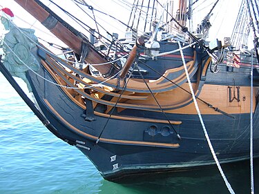 A boomkin projecting from the bow of HMS Surprise (in center of image) HMS Surprise (replica ship) port side 8.JPG