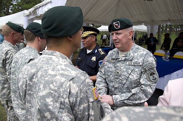 Brigadier General Sean Mulholland, SOCSOUTH Commander in 2014, honors 7th SFG(A) soldiers in Honduras