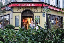 Art deco facade of an old store. The site was accommodating the former Jewish delicatessen "Chez Jo Goldenberg", where an attack occurred on August 9, 1982, carried out by Abu Nidal Organization. Jo Goldenberg, Rue des Rosiers, Paris September 2016.jpg