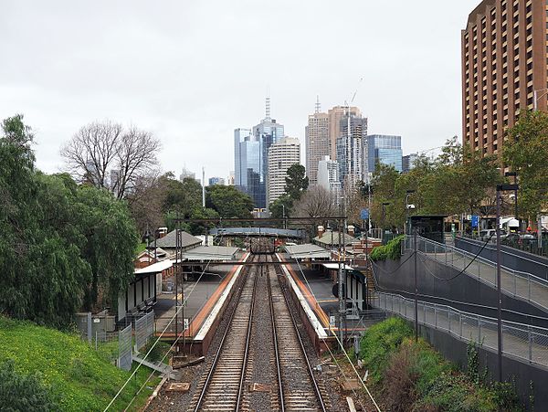 Westbound view of station platforms and buildings with partial views of Melbourne CBD, August 2016