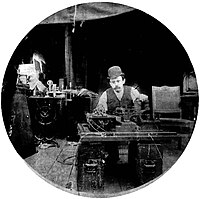 Charles Kayser of the Edison lab seated behind the Kinetograph. Portability was not among the camera's virtues. KinetographKayser2bis.jpg