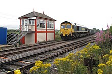 A train loaded with granite chippings from Bardon Hill quarry departs south from the exchange sidings on the former Leicester and Swannington Railway