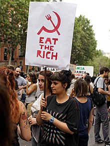 Woman with slogan and a hammer and sickle symbol with a fork instead of a hammer (Madrid, 2012) Madrid - 12-M 2012 demonstration - 193323.jpg