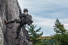 Spc. Glen Mallett of the Maine Army National Guard kicks off the wall while rappelling down the rock face at Eagles Bluff Maine National Guard (37175025524).jpg