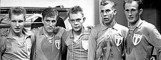 A black and white photograph of five football players standing beside each other in a locker room after a match. The players are noticeably tired; large sweat stains are visible on their shirts.