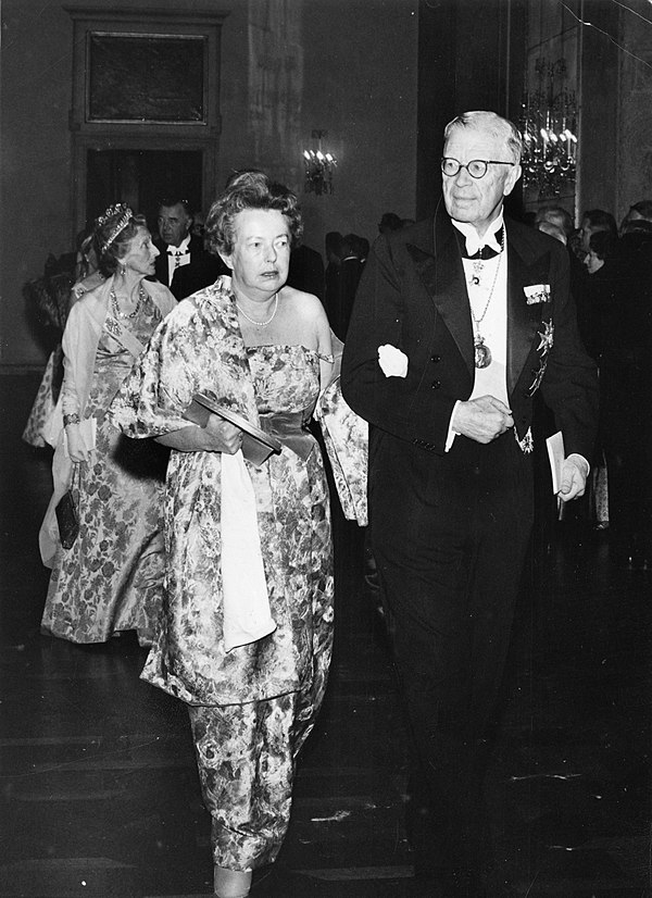 Maria Goeppert Mayer walking into the Nobel ceremony with King Gustaf VI Adolf of Sweden in 1963