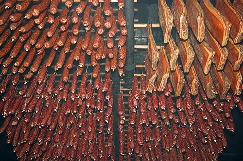 Meat hanging inside a smokehouse in Switzerland