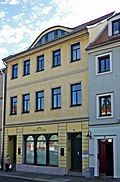 Residential building with shop in closed development