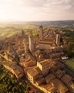 view of the roofs and nearby streets in the evening. Towers and landscape of Tuscany.