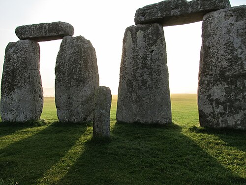 Standing in the shadows of Stonehenge during a fall sunrise