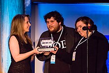 Deborah Hyde grants the 2013 Editor's Choice Ockham to The Pod Delusion team. The Pod Delusion Wins the Editors' Choice Ockham Award 2013.jpg