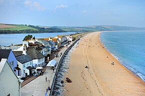 Looking down on Torcross and Slapton Sands from Torcross Point. Slapton Ley is visible behind the houses. Torcross September 2015.jpg