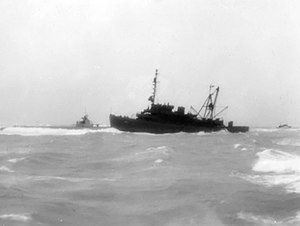 USS Macaw (ASR-11) and USS Flier (SS-250) aground at Midway Atoll, 16 January 1944.jpg