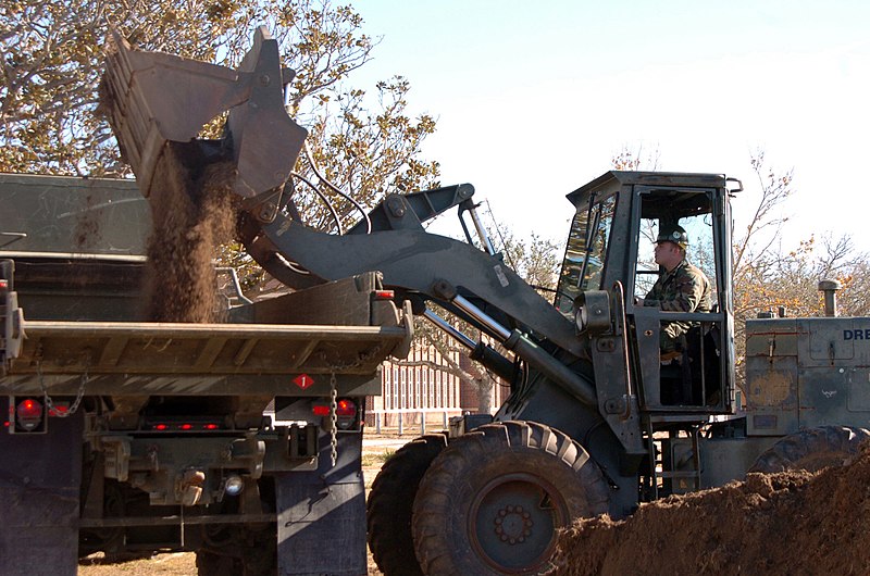 File:US Navy 051227-N-2300P-021 Equipment Operator 3rd Class Justin Hallahan assigned to Naval Mobile Construction Battalion Seven (NMCB-7) uses a front-end loader to clear dirt and debris in downtown Gulfport, Miss.jpg