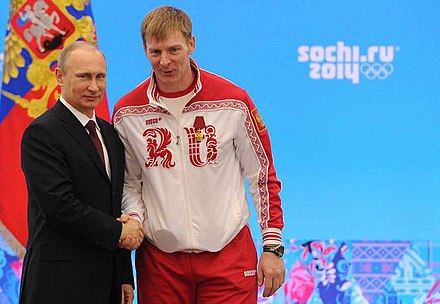 Vladimir Putin awards Alexandr Zubkov at the ceremonies for Russian athletes, 24 February 2014.  Zubkov would be stripped of his gold medals 3 and a half years later.