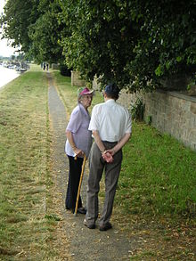 Walkers looking towards the old Bromley Arms pub and mooring showing flood defence wall to right