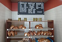 Traditional bakery shelves of Scali bread, with pricing, 2023. Winter Hill Bakery, Somerville MA. A display of Scali bread at the Winter Hill Bakery.jpg