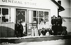 Girls smiling while child looks on in front of Buffalo Lake General Store