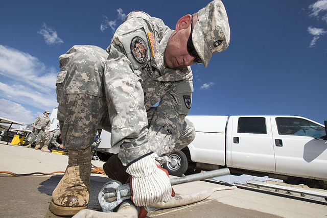 Sgt. Shawn Ludolph of the Colorado Army National Guard connecting fire hoses together during a training exercise