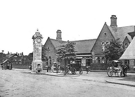 Didsbury railway station shortly after the erection of the Rhodes memorial clock, c.1910