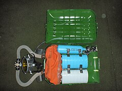IDA-71 with lid of casing opened showing interior with counterlung, scrubber canisters and oxygen supply cylinder and regulator