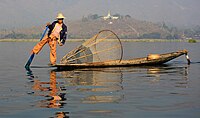 English: Fisher at en:Inle Lake. Buddhist temple in the background.