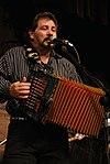 Cajun musician Jo-El Sonnier singing while playing an accordion.