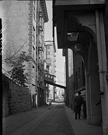 View of Angels Flight as it passes over Clay Street in 1955 Know Your City No.3 View down alleyway at Angels Flight car Los Angeles, Calif. 1955.jpg