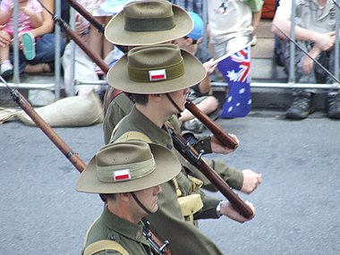 Marchers in World War II Australian uniforms, wearing the colour patch of the 2/8th Battalion. ANZAC Day Parade in Brisbane, Queensland, 25 April 2007. This colour patch was based on that of the 8th Battalion, 1st AIF, with grey trim to distinguish it as the colour patch of a unit of the 2nd AIF. Marchers in WWII Australian uniforms, wearing the colour patch of the 2-8th Battalion - 070425 Anzac Day March, Adelaide St, Brisbane, Queensland, Australia.jpg