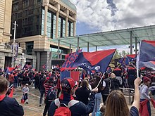 Demons fans celebrate at Forrest Place in Perth following Melbourne's 2021 premiership win the previous day over the Western Bulldogs at Optus Stadium Melbourne fans celebrate grand final win.jpg