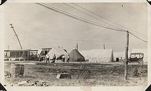 Men relaxing at Stone & Webster Engineering camp at Virginia Point, Texas following 1915 Galveston Hurricane Men loitering at Stone & Webster Engineering camp at Virginia Point (close-up).jpg