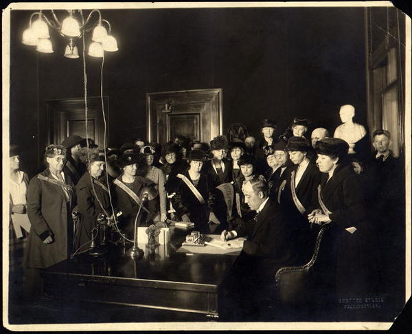 Morrow signs the bill ratifying the 19th Amendment, Kentucky Equal Rights Association members look on in celebration, January 6, 1920.