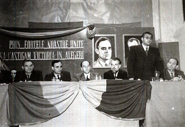 Official tribune at the PCR–PSDR summit at Paris Cinema, October 23, 1946. Constantinescu is speaking; also pictured: Ștefan Voitec, Gheorghe Gheorghi