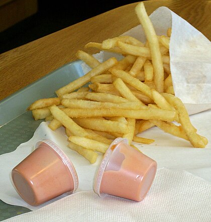 Fry sauce in sealed plastic cups with fries on a tray in Utah