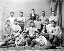 "The Pirates", Carlisle Indians college football team of 1879 Portrait of College Football Team, The "Pirates," in Partial Uniform, and with Man in Business Suit 1879.jpg
