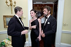 US President Ronald Reagan, Audrey Hepburn, and Robert Wolders at a private dinner for the Prince of Wales at the White House, Washington, D.C., United States (1981)