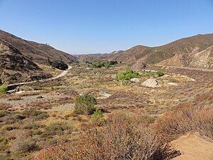 Concrete ruins of the St. Francis Dam remain strewn about San Francisquito Canyon in 2012 Saint Francis Dam Site 2012.jpg