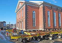 Hydraulically powered dollies move a historic 19th-century brick church in Salem, Massachusetts. Salem Church Relocation.JPG