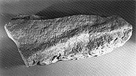 A fragment of the Singapore Stone, inscribed with an Indic script. SingaporeStone-bwphoto.jpg