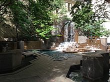 Park features a 30-foot (9.1 m) cascading waterfall fountain. Thomas Polk Park.jpg