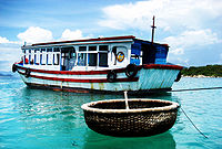 A popular fishery boat and a round bamboo coracle in Nha Trang