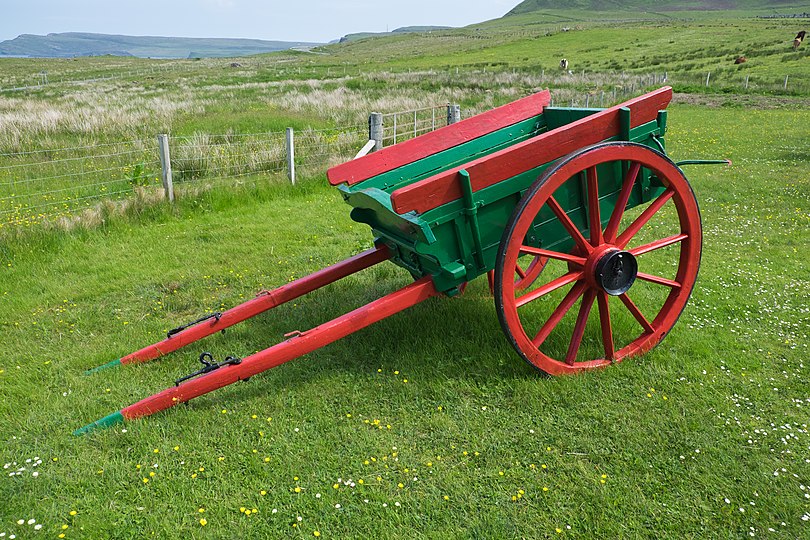 A two-wheeled horse-drawn farm cart on display