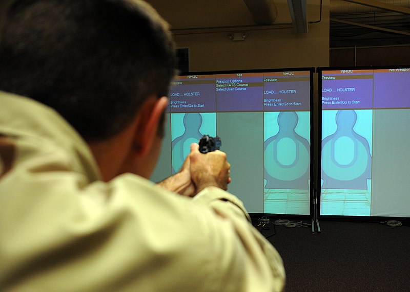 File:US Navy 090818-N-2004W-113 A Sailor takes aim while competing in a fire arms training simulator during the 2009 San Diego Surface Line Week.jpg