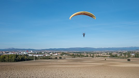 Paraglider coming down from Olarizu mountain. Vitoria-Gasteiz, Basque Country, Spain