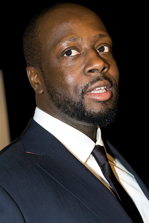 Having previously collaborated with Shakira on "Hips Don't Lie", Wyclef Jean (pictured) was featured on the song "Spy" in She Wolf.